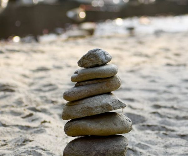 Minimalist zen garden stones on white sand